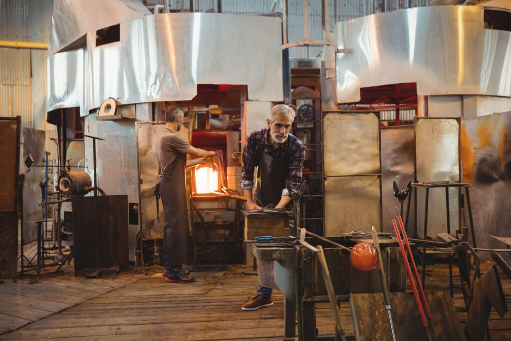 Header image showing glassblowers in a workshop